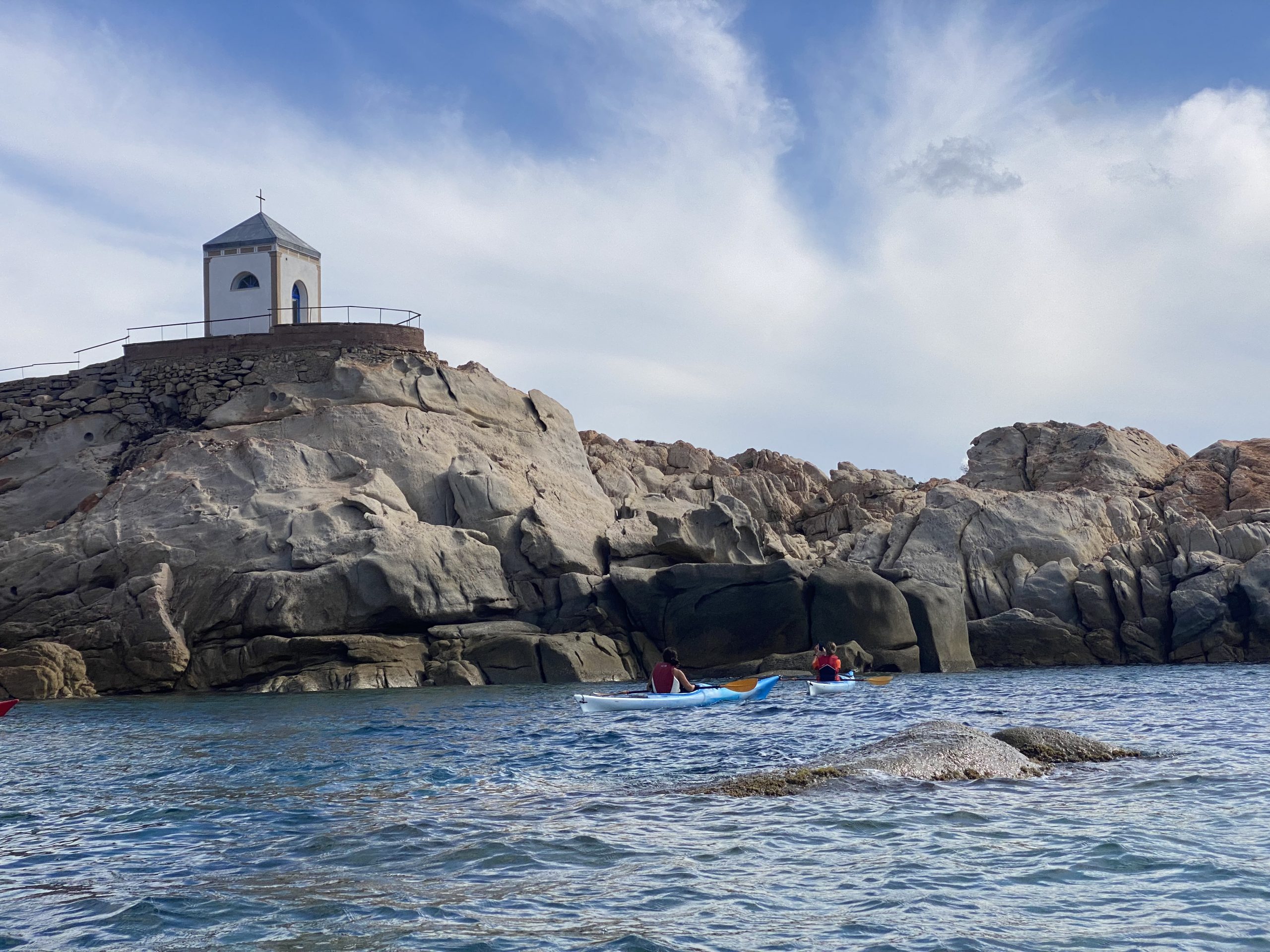 Kayakers exploring the granite coastline of the La Maddalena Archipelago in Sardinia