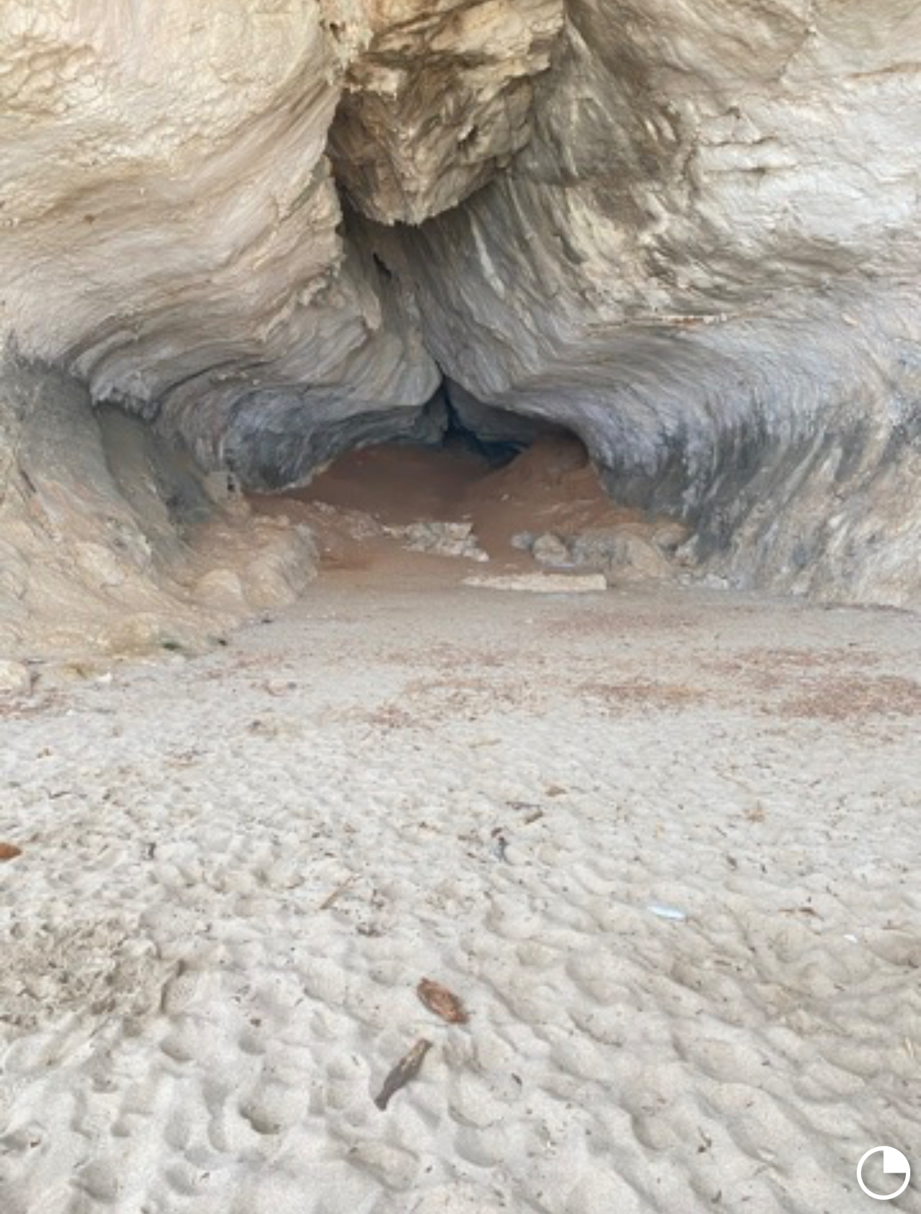 Large limestone caves opening onto Cala Luna beach in the Gulf of Orosei, Sardinia