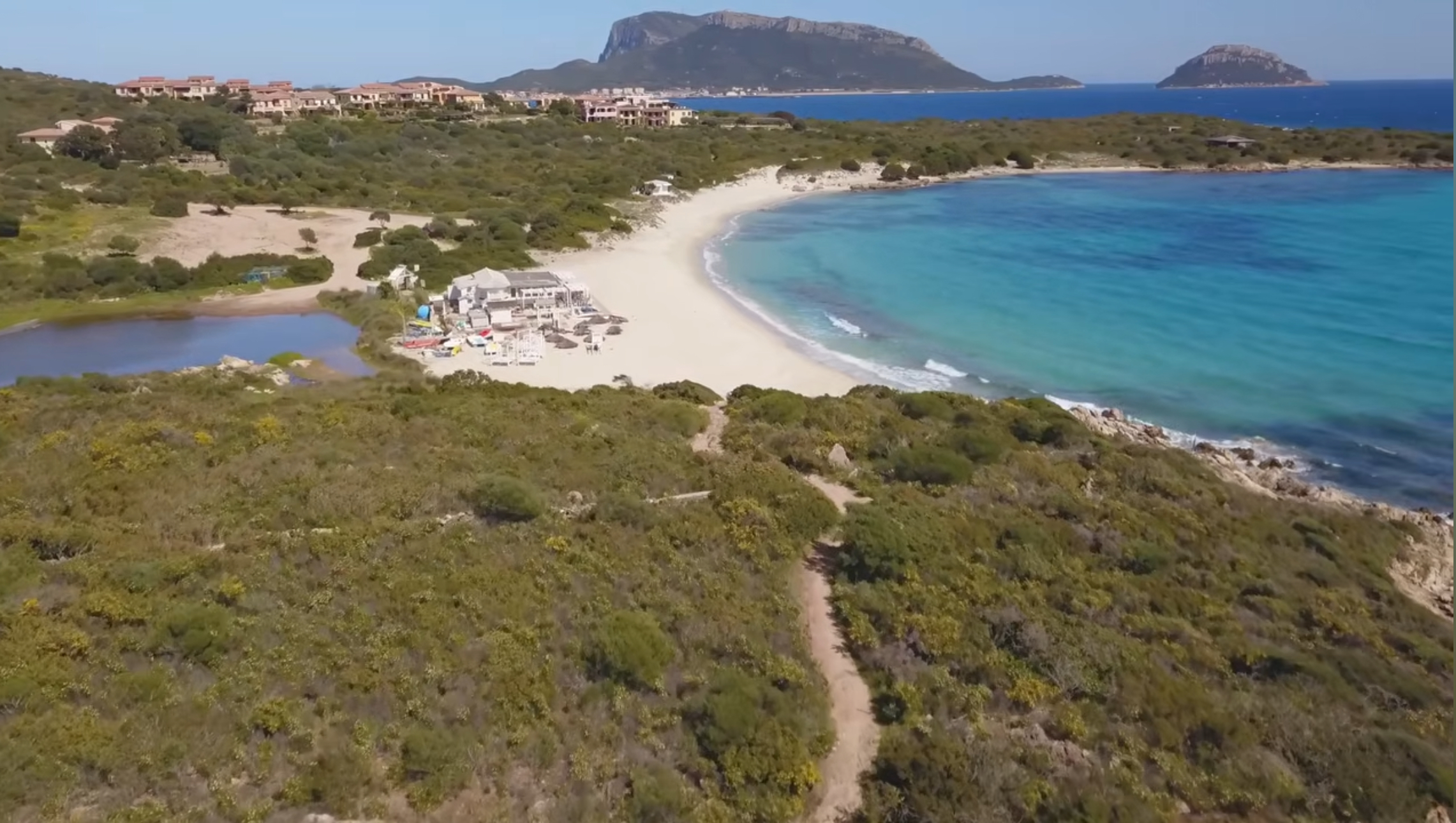 Aerial view of Spiaggia Bianca near Golfo Aranci with Capo Figari and Figarolo Island in the distance