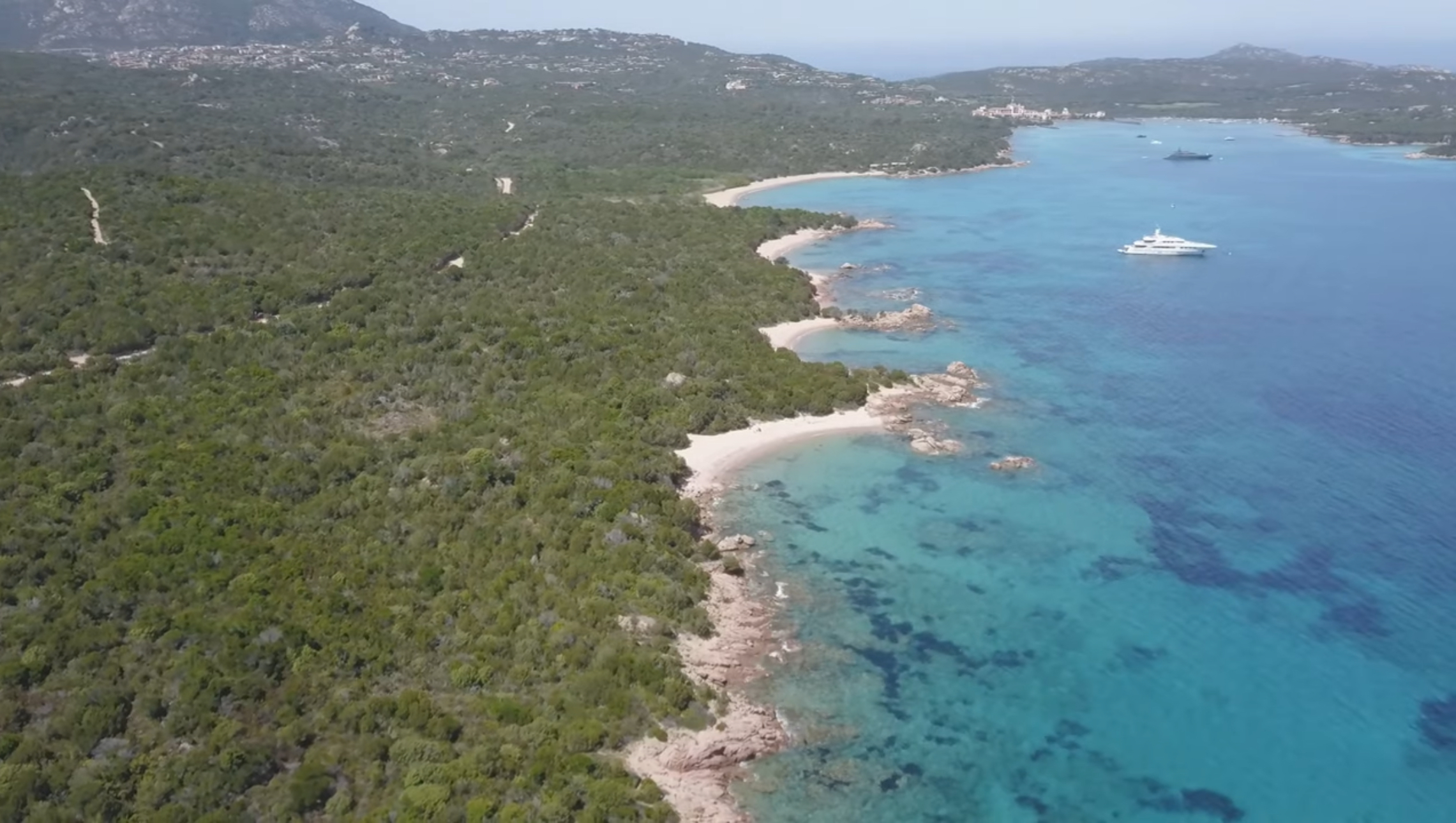 Aerial panorama of granite coves and turquoise water along northeast Sardinia