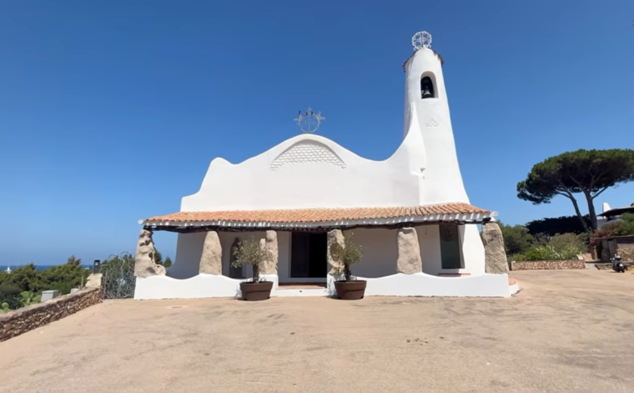 White curved façade and bell tower of Stella Maris Church in Porto Cervo